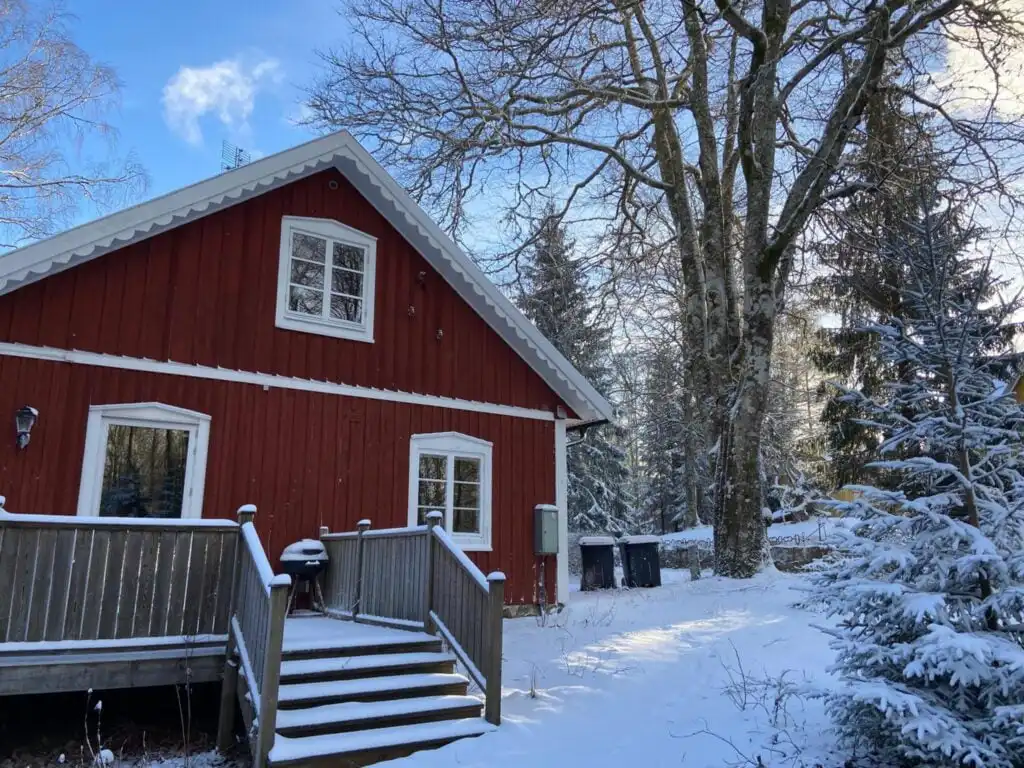 Ferienhaus Torsholma Skolhus im Winter – rotes Schwedenhaus in verschneiter Landschaft in Småland