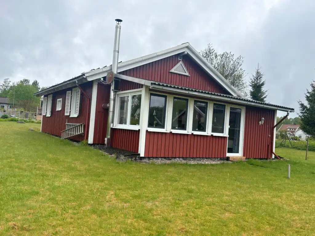 Außenansicht des roten Ferienhauses in ruhiger Lage